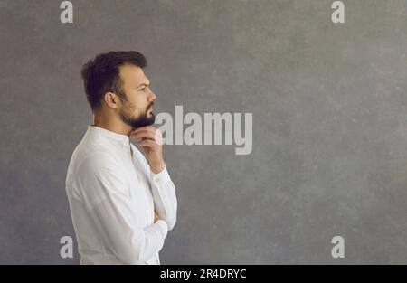 Profile view of a serious caucasian man who is thinking about the future or making a decision. Stock Photo