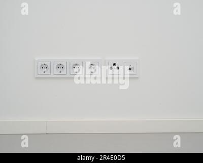 Modern sockets in the wall. Multifunctional socket with internet connection. European sockets. Stock Photo