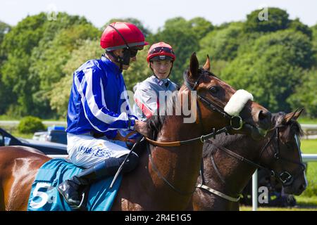 York, UK. 27th May 2023. Jockeys Tom Eaves and Rowan Scott chat before the start of a race at York racecourse. Credit: Ed Clews/Alamy Live News. Stock Photo