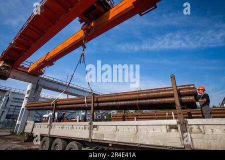 Podolsk, Moscow province - August 02, 2021: Pipes warehouse. Loading pipes with overhead crane. Stock Photo