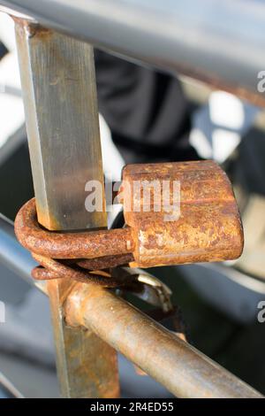 Rusty old padlock on an old gate Stock Photo