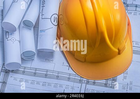 An Yellow Construction Helmet On Background Of Blueprints Stock Photo