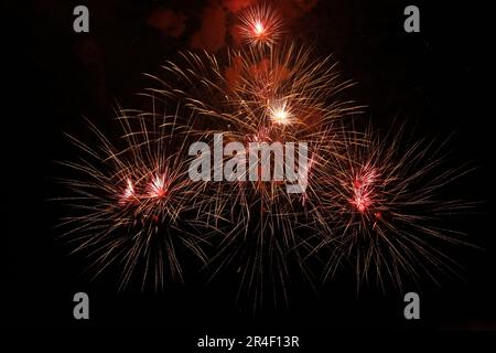 Beautiful fireworks lighting up night sky outdoors Stock Photo