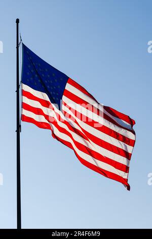 United States of America Stars and Stripes national flag fluttering on pole Stock Photo