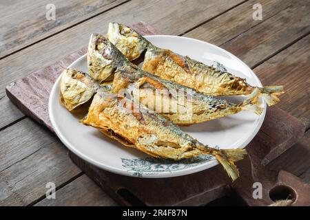 Ikan Mabong goreng or fried Mackerel fish. Fried dry with turmeric seasoning. Stock Photo