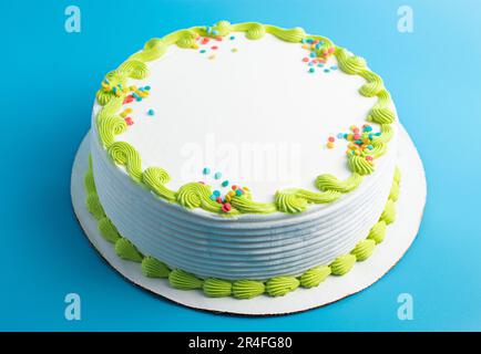 A Circular White Ice Cream Cake with Colorful Border and Sprinkles Stock Photo