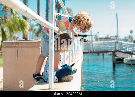 Children boy and girl fishing with fishing rod. Summer children lifestyle.  Kids fishing on weekend. Two young cute children fishing on a lake in a  Stock Photo - Alamy