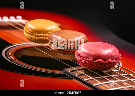 Macarons in a row on guitar strings Stock Photo