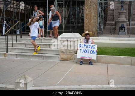 Houston, USA. 27th May, 2023. A protestor holds a sign that reads 'Remove Paxton! Unfit for Office' in front of the Taxas Capitol building in Austin, Texas, the United States, May 27, 2023. The GOP-led Texas House of Representatives on Saturday voted to impeach Attorney General Ken Paxton, a powerful Republican and firm ally of former President Donald Trump in the second largest U.S. state, over yearslong accusations of corruption, lawbreaking and power-abusing. Credit: Bo Lee/Xinhua/Alamy Live News Stock Photo