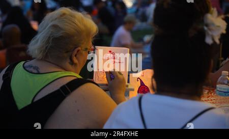 Houston, USA. 27th May, 2023. Two women draw on lanterns during the Water Lantern Festival held in Houston, Texas, the United States, May 27, 2023. Credit: Xu Jianmei/Xinhua/Alamy Live News Stock Photo