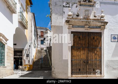 Evora, Portugal - June 30, 2022: Street in the old town with typical whitewashed houses with balconies. Alentejo, Portugal Stock Photo