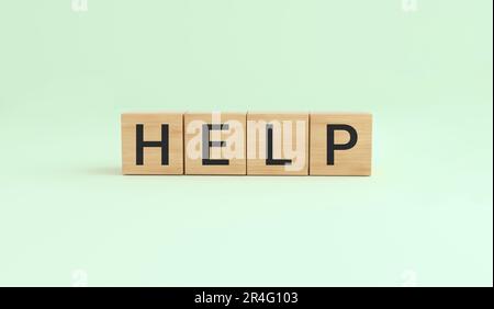 Concept word help on wooden cubes on green background. 3D rendering. Stock Photo