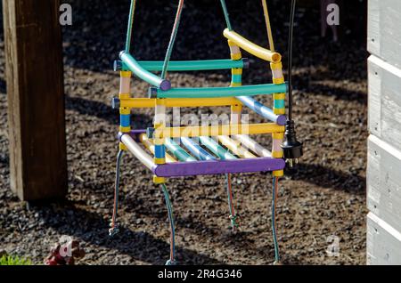 Children's slide with swings in summer, in the village Stock Photo