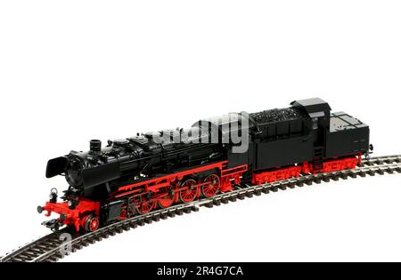 Isolated toy steam locomotive with a coal trailer Stock Photo