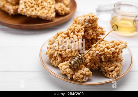 Puffed rice bars (kozinaki) on white wooden table, closeup Stock Photo