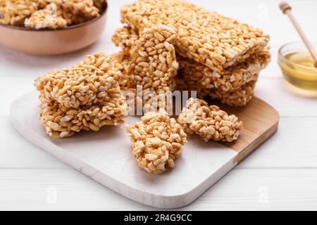 Puffed rice bars (kozinaki) on white wooden table, closeup Stock Photo