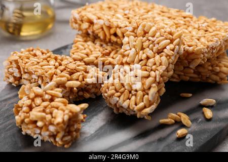 Puffed rice bars (kozinaki) on board, closeup Stock Photo