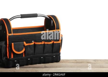 Empty bag for tools on wooden table against white background Stock Photo