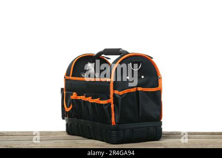 Empty bag for tools on wooden table against white background Stock Photo
