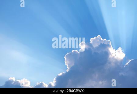 Fantastic Sunbeam Shining Through the Fluffy Clouds Stock Photo