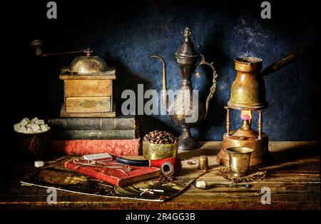 Classic still life with traditional Turkish coffee placed on coffee heater(Alcohol Burner),vintage grinder, old books, antique jar, sugar and pipe. Stock Photo