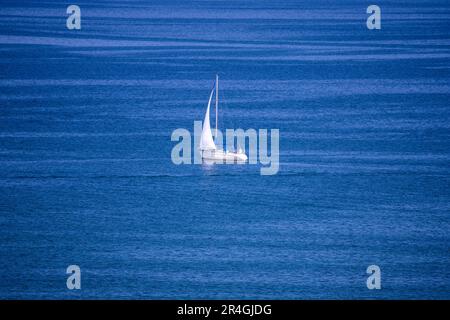 Rostock, Germany. 28th May, 2023. A sailboat cruises on the Baltic Sea in front of Warnemünde. With lots of sunshine and warm temperatures, the weather shows its best side on Whit Sunday in northern Germany. Credit: Jens Büttner/dpa/Alamy Live News Stock Photo