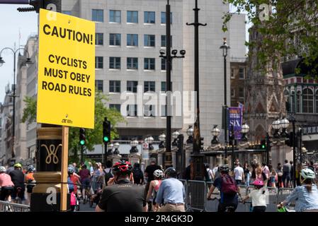 Westminster, London, UK. 28th May, 2023. As part of the three-day RideLondon cycling event a large route around the centre of London has been closed to traffic to allow members of the public to ride past the city’s landmarks free of other vehicles. Sign reminding cyclists to obey road rules Stock Photo