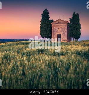 Stunning photography and touristic place in Tuscany, cute old Vitaleta chapel in the grain field at sunset, Pienza, Tuscany, Italy, Europe Stock Photo