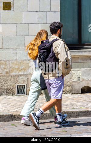 Young couple walking along street - Tours, Indre-et-Loire (37), France. Stock Photo