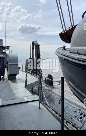 Outside details of retired vintage military naval sea vessel navy warship number, heavy machine gun, nautical flag, antenna, bridge of destroyer Stock Photo