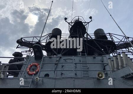 Outside details of retired vintage military naval sea vessel navy warship number, heavy machine gun, nautical flag, antenna, bridge of destroyer Stock Photo