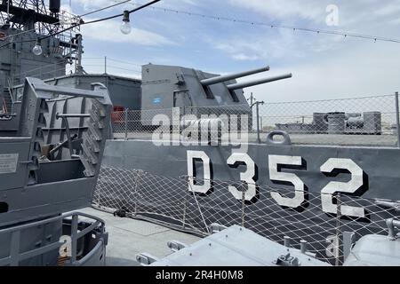 Outside details of retired vintage military naval sea vessel navy warship number, heavy machine gun, nautical flag, antenna, bridge of destroyer Stock Photo