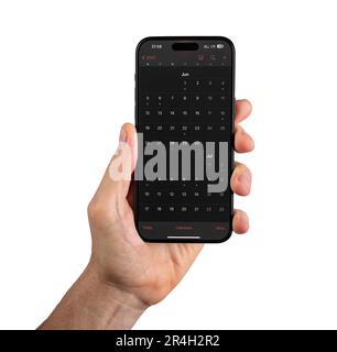 Lodz, Poland May 14 2023 Calendar app in dark mode on mobile phone isolated on white. Stock Photo