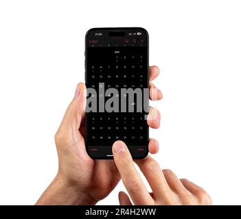 Lodz, Poland May 14 2023 Calendar application in dark mode on smart phone isolated on white. Stock Photo