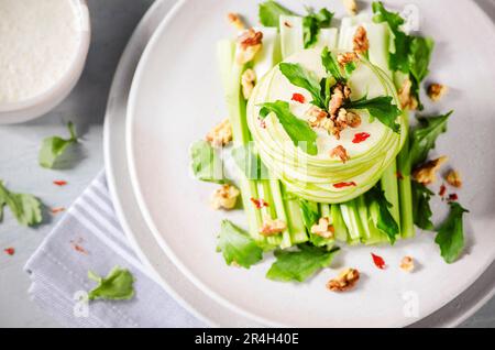 Waldorf Salad with green apples, celery, watercress and roasted walnuts on a plate. Stock Photo