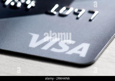 Detail of an international payment and withdrawal bank card with the Visa logo shot close-up. Visa is an American payment system used worldwide Stock Photo