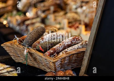 Sausages and meat products variety in a basket, store display closeup view Stock Photo
