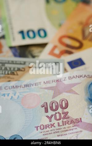 100 turkish lira on us and Eu currency background. Turk money theme Stock Photo