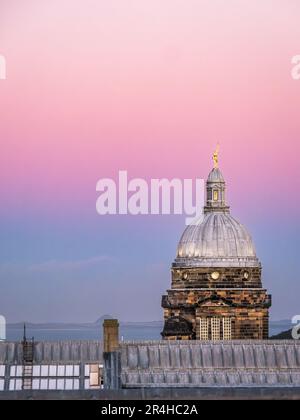 Sunset view of rooftop skyline, Old College dome, University of Edinburgh, Edinburgh, Scotland, UK, with pink sky Stock Photo