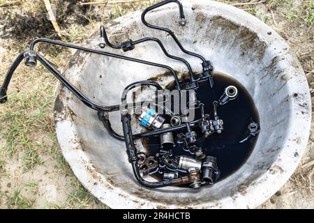 A fuel pump has all connector elements separated from the tractor engine for repair. Stock Photo