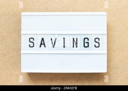 Lightbox with word savings on wood background Stock Photo