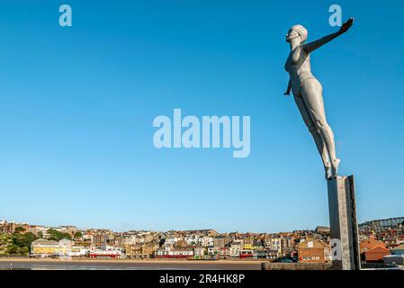 The Diving Belle Sculpture next to the Lighthouse at the harbour of Scarborough, North Yorkshire in England Stock Photo