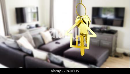 Golden hanging house key against interior of a modern living room Stock Photo