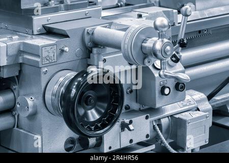 Lathe control knobs close up blue tone. Metal machine tools industry. The metalworking process by turning machine. industry metal processing concept b Stock Photo
