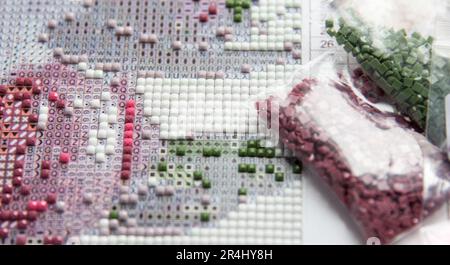 Process of creation of color diamond painting 3d from square ostrich, handmade hobby for rest Stock Photo