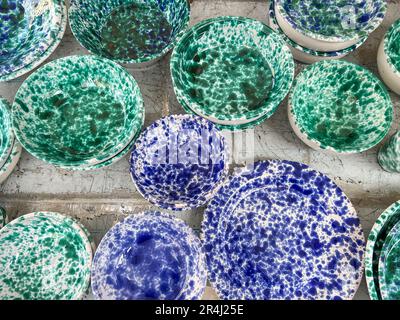 ceramics, top view handmade blue and green colored ceramic or clay plates and bowls as a background. handmade blue and green porcelain or ceramic plat Stock Photo