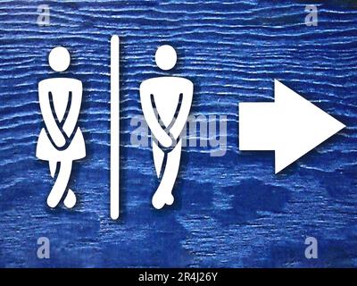 public toilet sign board with white woman and man figure and arrow on blue background or surface. public toilet or wc sign board photo with copy space Stock Photo