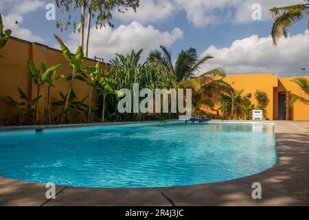 Swimming pool in tropical paradise with palm trees around and crystal clear blue water, perfect touristic destination for relax and holidays Stock Photo