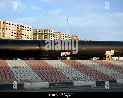 Cairo, Egypt, May 18 2023: preparations to place large water pipe parts in place, sanitation pipes, improvement of infrastructure and real estate deve Stock Photo