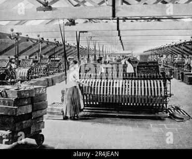 A late 19th century view of a vast linen factory in Belfast, Northern Ireland. The wet spinning and reeling is done by females, each tending upto 24 spindles. The industry at the time employed over 40% of the working population Stock Photo